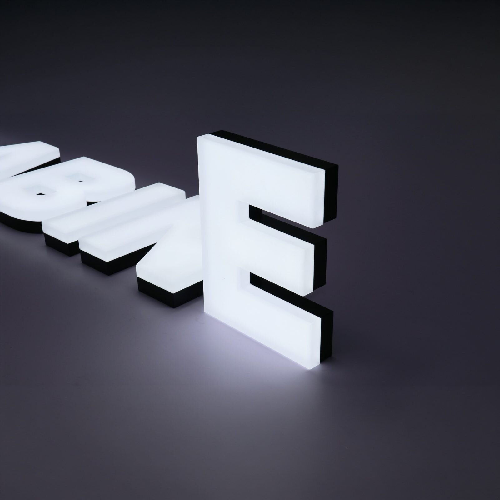 Bright uniform white front-lit custom channel letters in factory, consistent LED brightness across all characters