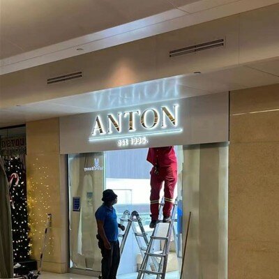 Gold mirror backlit channel letters at mall storefront, client installation