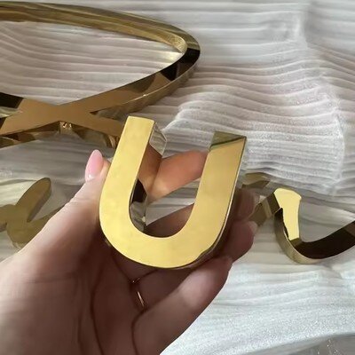 Mirror gold stainless steel channel letter close-up, customer product photo