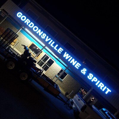 Blue front-lit channel letters on commercial building at night