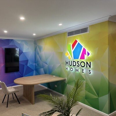 Colorful backlit logo sign at home builder office