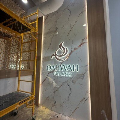 Backlit channel letters on marble feature wall, restaurant interior